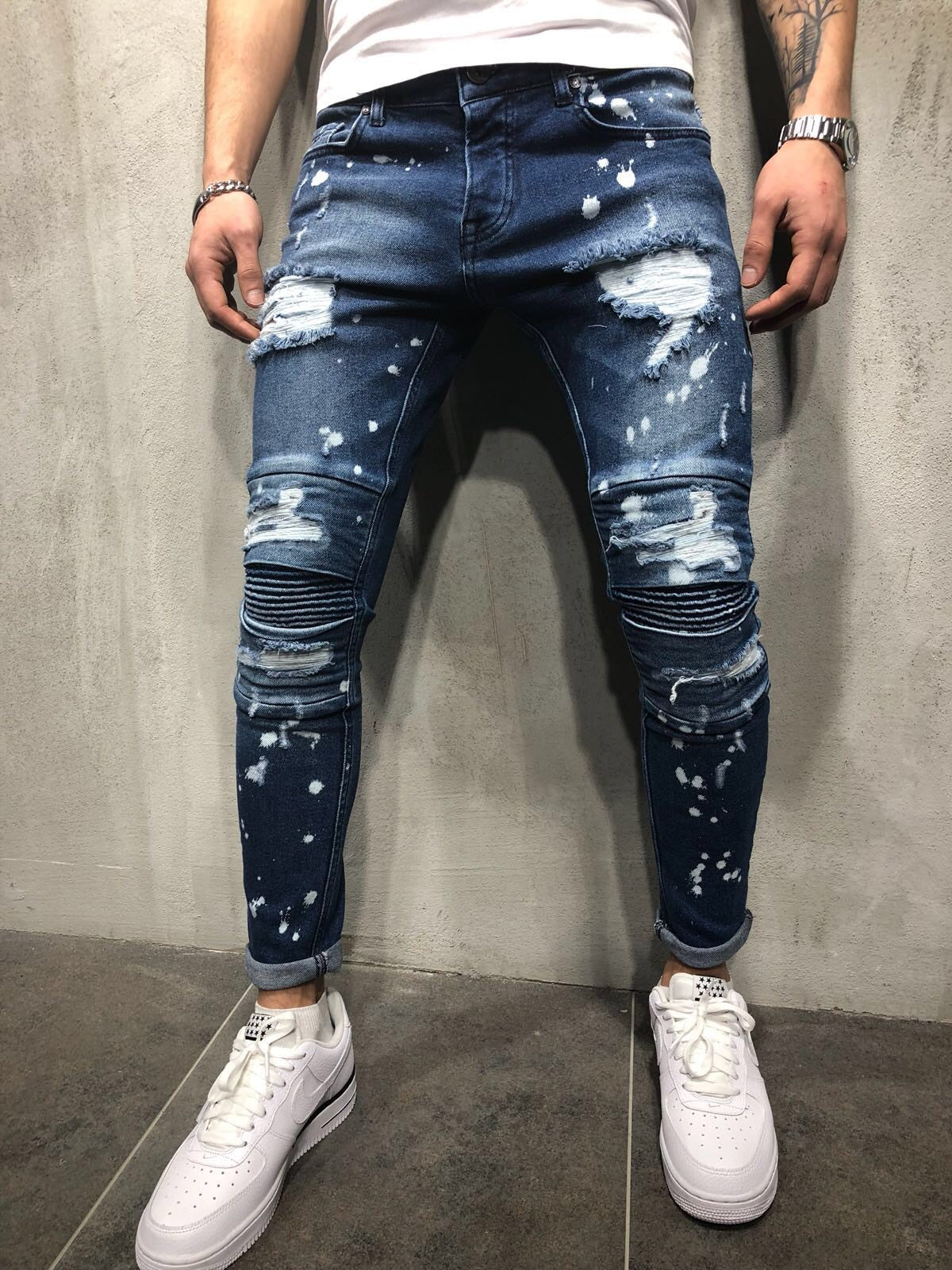 Men's European and American high street slim stretch jeans ripped spray paint white trousers pleated feet pants