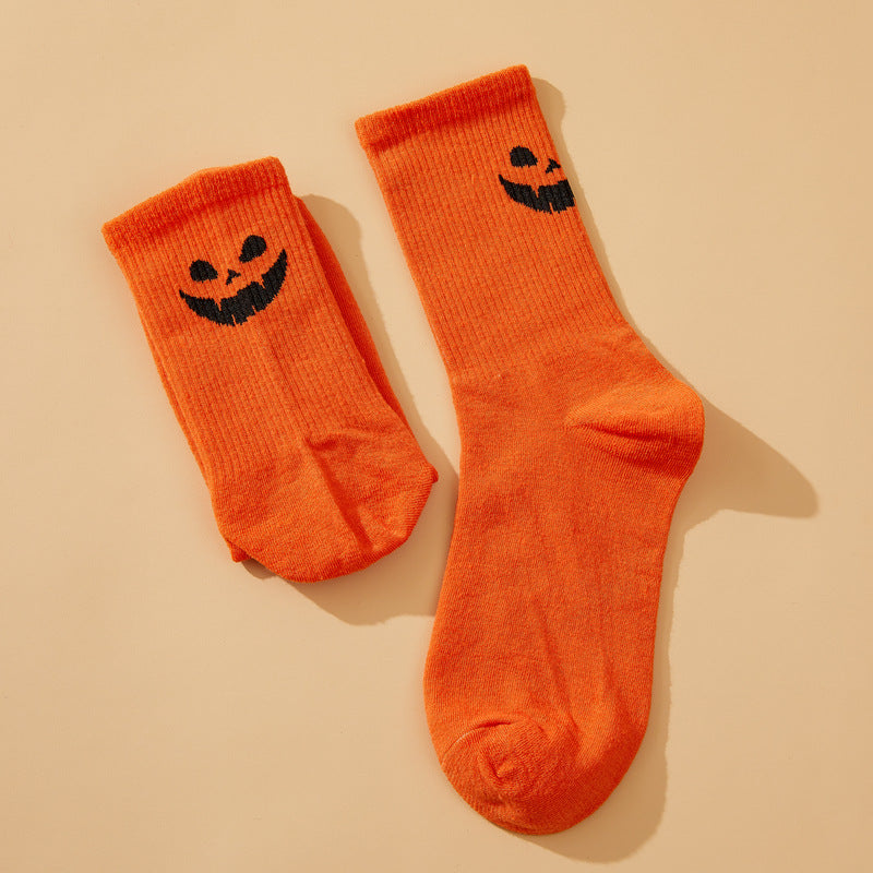 Solid color pumpkin face vertical pattern socks in Europe and the United States Halloween funny grimace personality trend socks